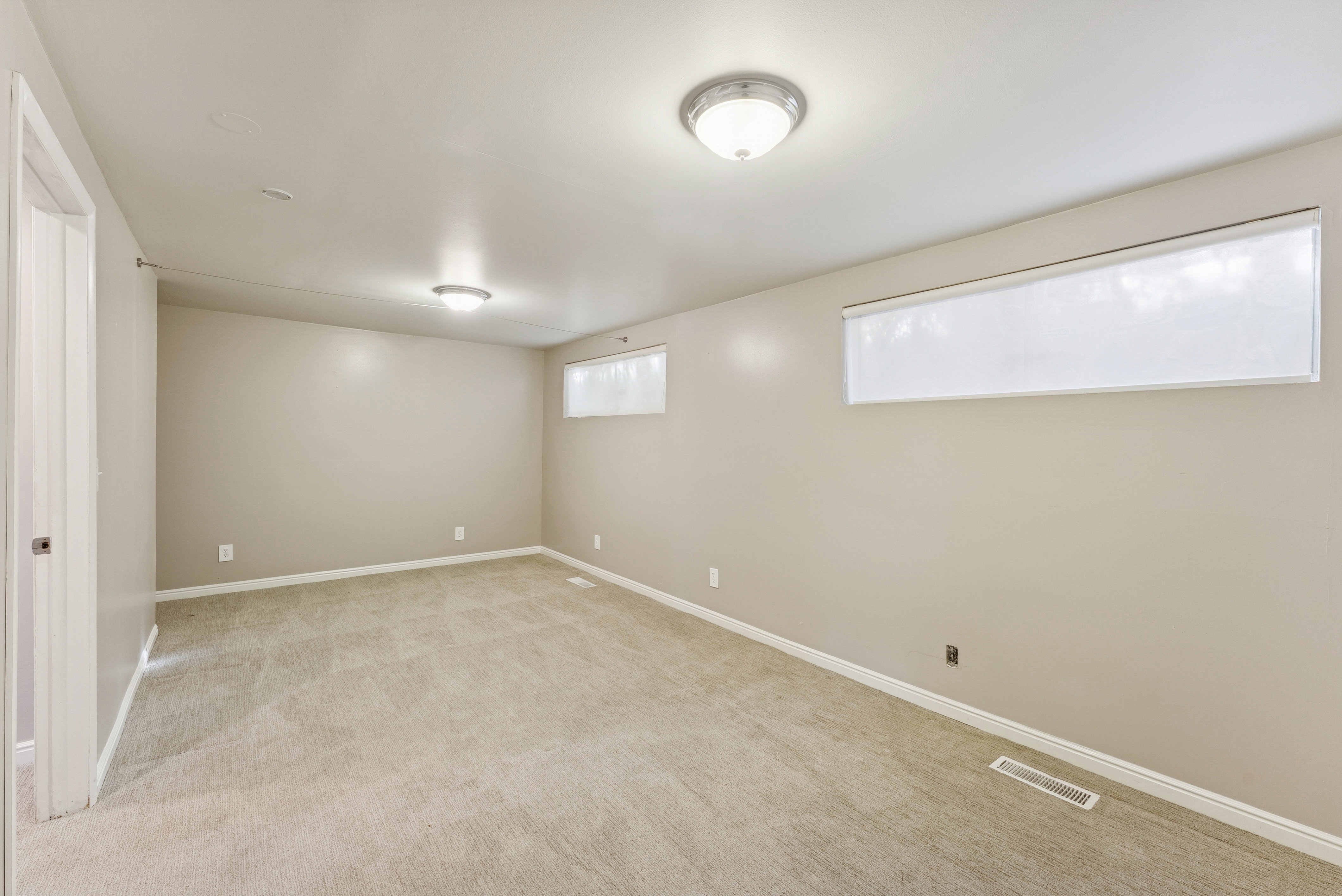 Below grade area with light carpet and baseboards