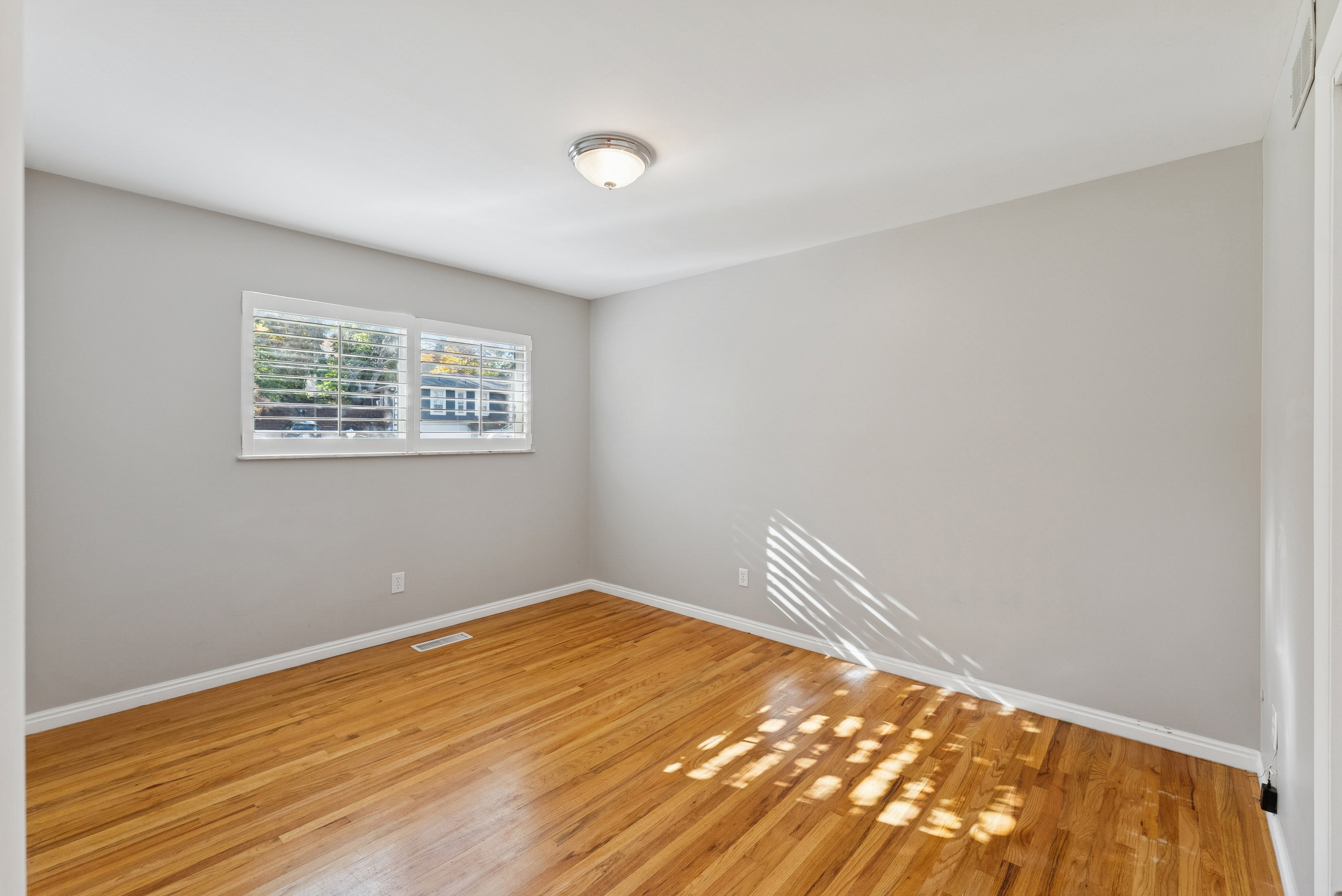 Empty room featuring baseboards and wood finished floors