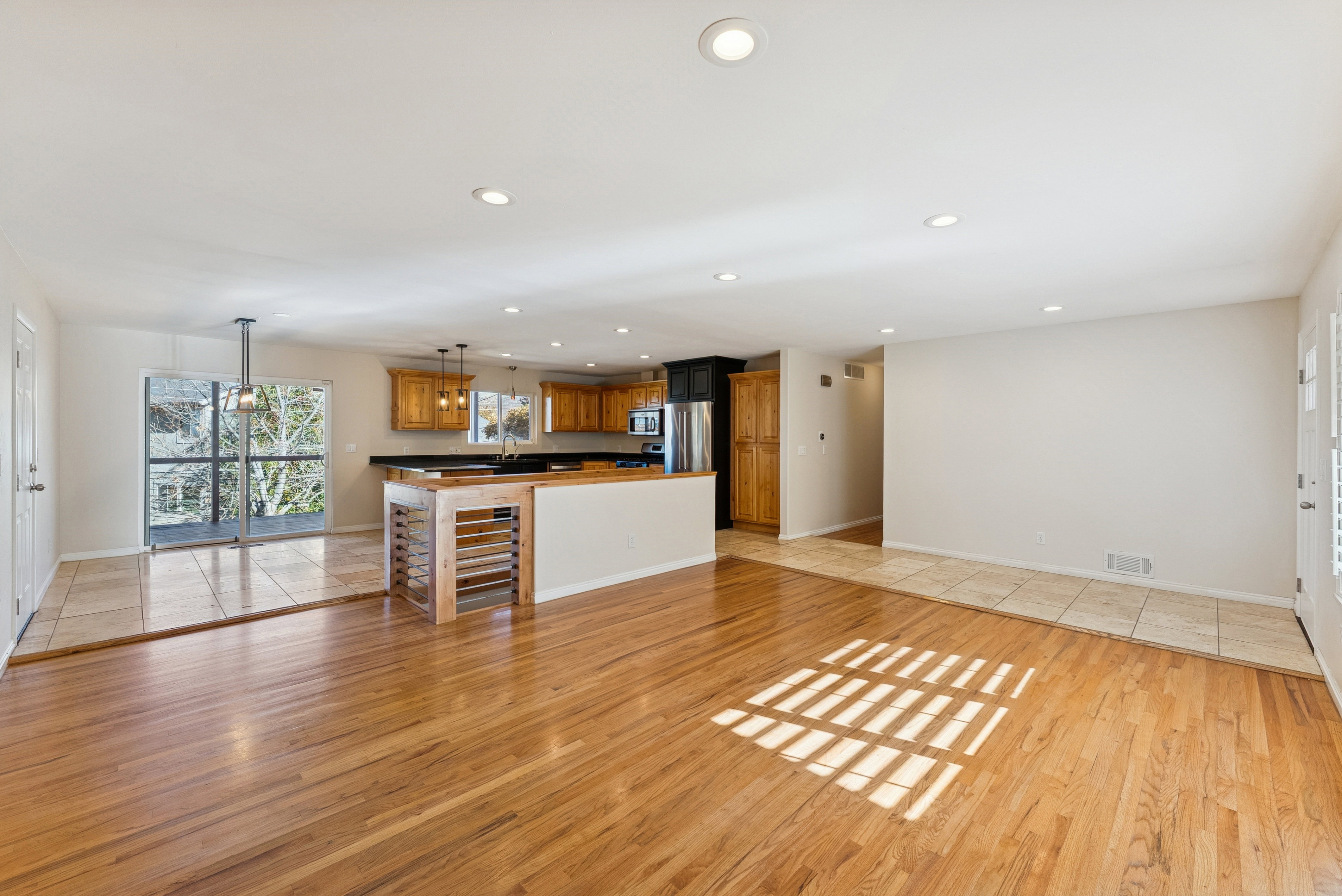 Unfurnished living room with light wood finished floors and recessed lighting