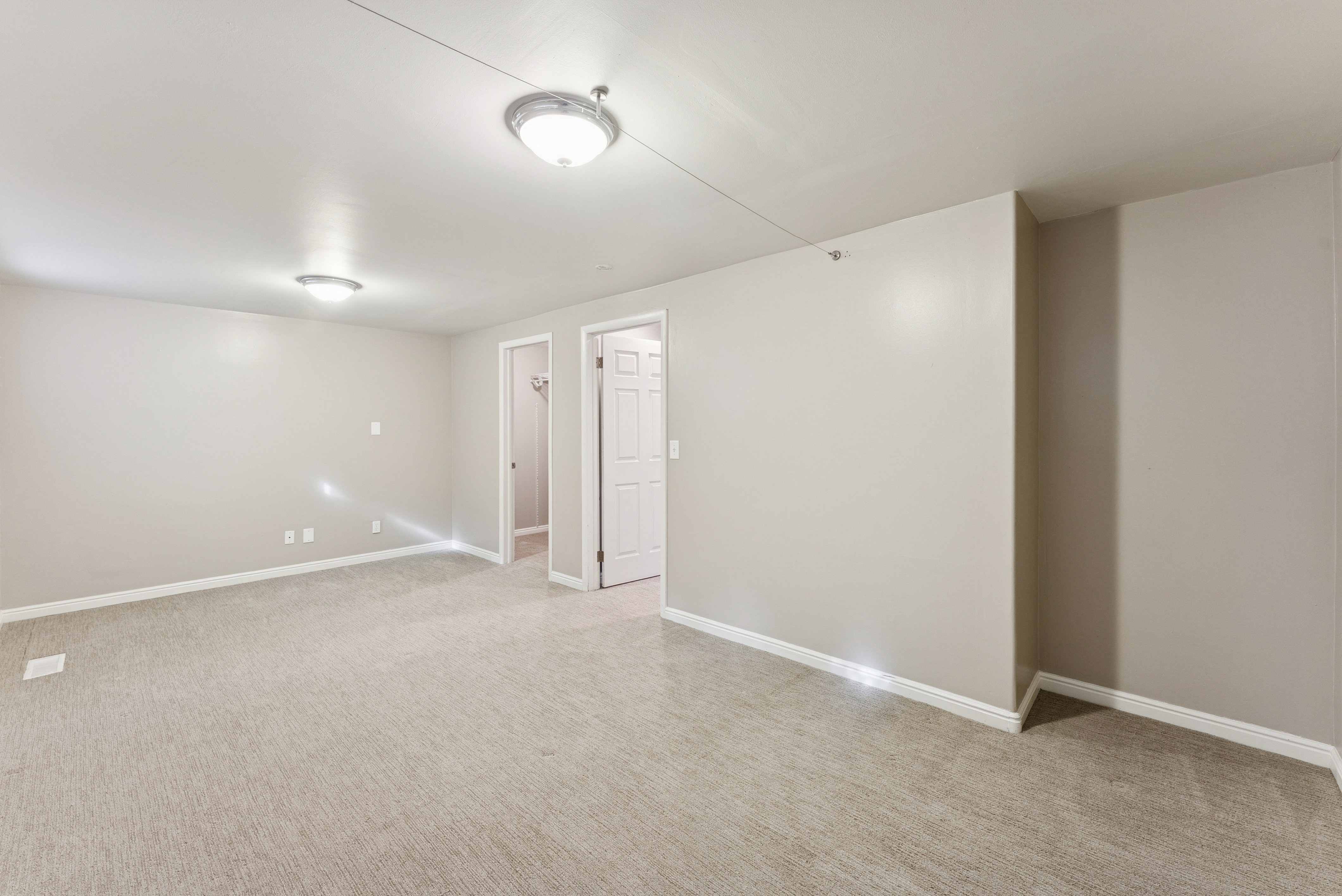 Below grade area with baseboards and light carpet