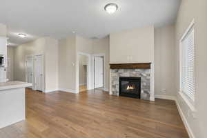 Unfurnished living room featuring light wood finished floors and a fireplace