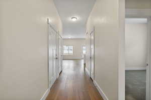 Corridor with baseboards and light wood-type flooring