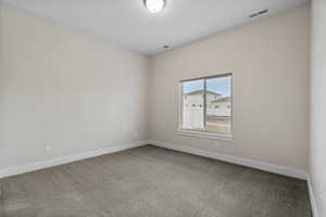 Empty room with carpet flooring and baseboards