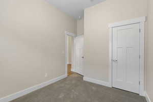 Unfurnished bedroom featuring carpet flooring and a closet