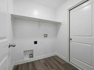 Laundry room featuring dark wood finished floors, hookup for a washing machine, and hookup for an electric dryer