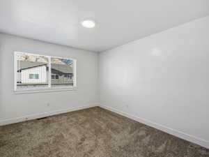 Unfurnished room featuring baseboards and carpet floors