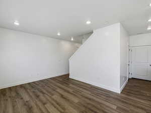 Below grade area featuring recessed lighting and dark wood-style flooring
