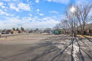 View of asphalt street featuring a residential view, a mountain view, and sidewalks