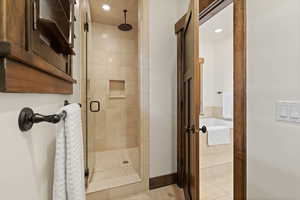 Bathroom featuring a stall shower and a garden tub