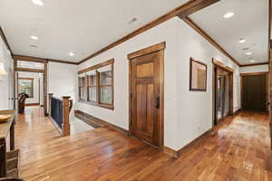 Hall featuring an upstairs landing, recessed lighting, light wood-style flooring, and ornamental molding