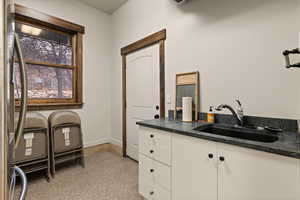 Mud room featuring a sink and baseboards