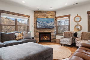 Living area featuring a stone fireplace,