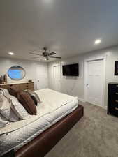 Carpeted bedroom with recessed lighting and a ceiling fan