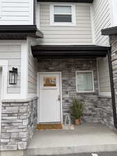Property entrance with stone siding