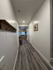 Corridor with baseboards and dark wood-style flooring