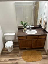 Full bathroom with vanity and light wood-type flooring
