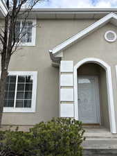 View of exterior entry featuring stucco siding