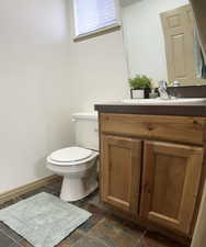 Bathroom with vanity and stone tile flooring