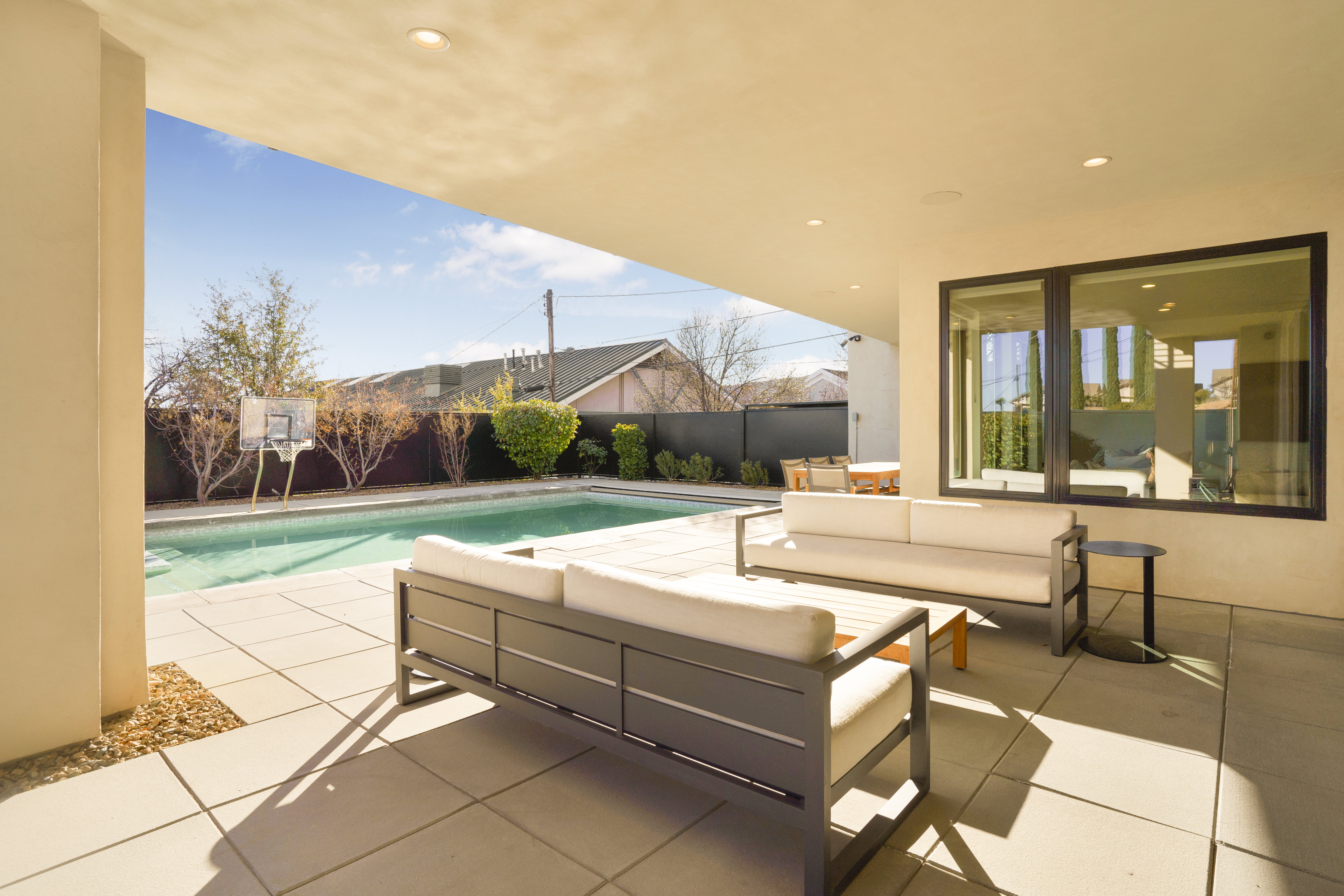 Fenced backyard with outdoor furniture and a patio
