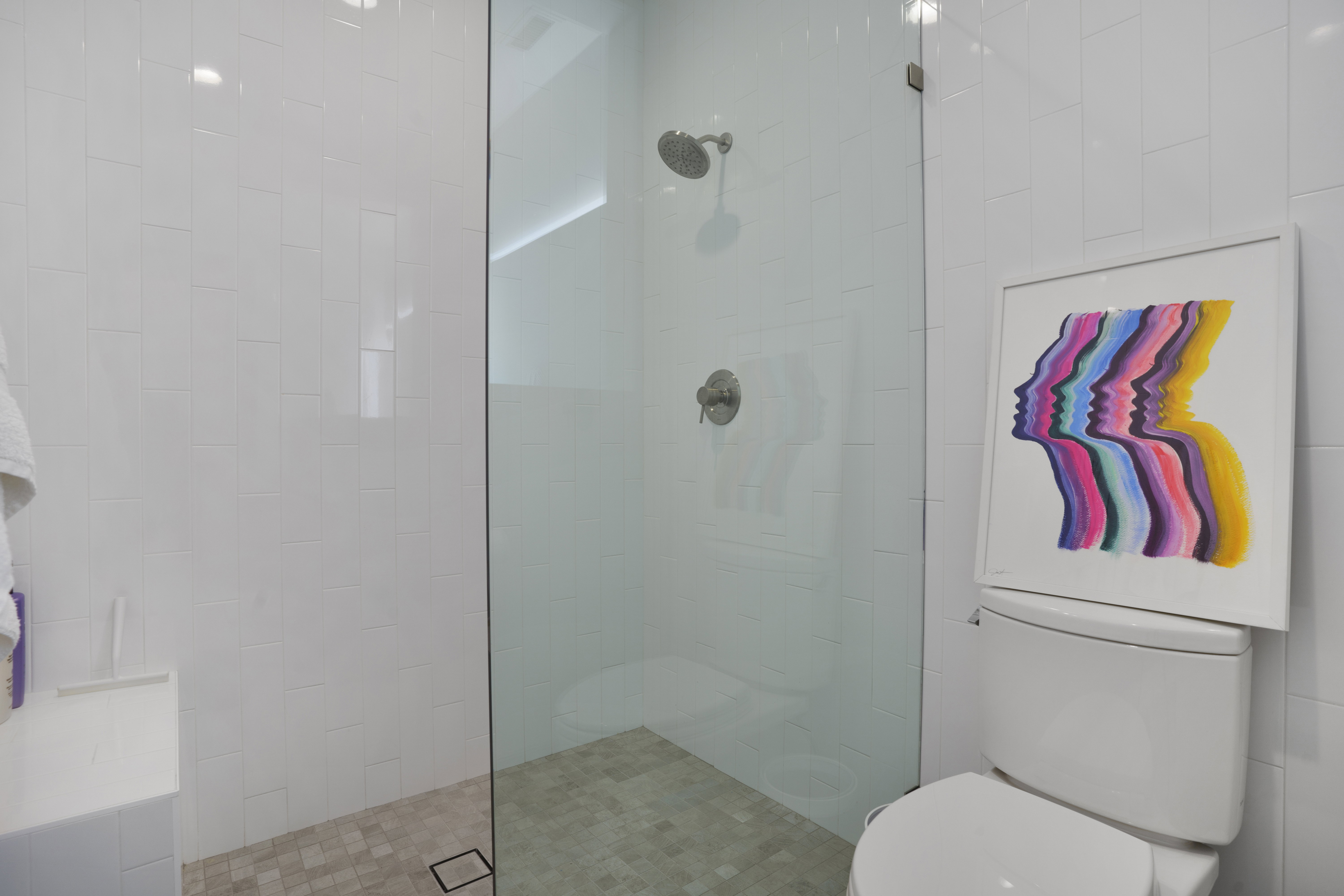 Bathroom featuring walk in shower and toilet
