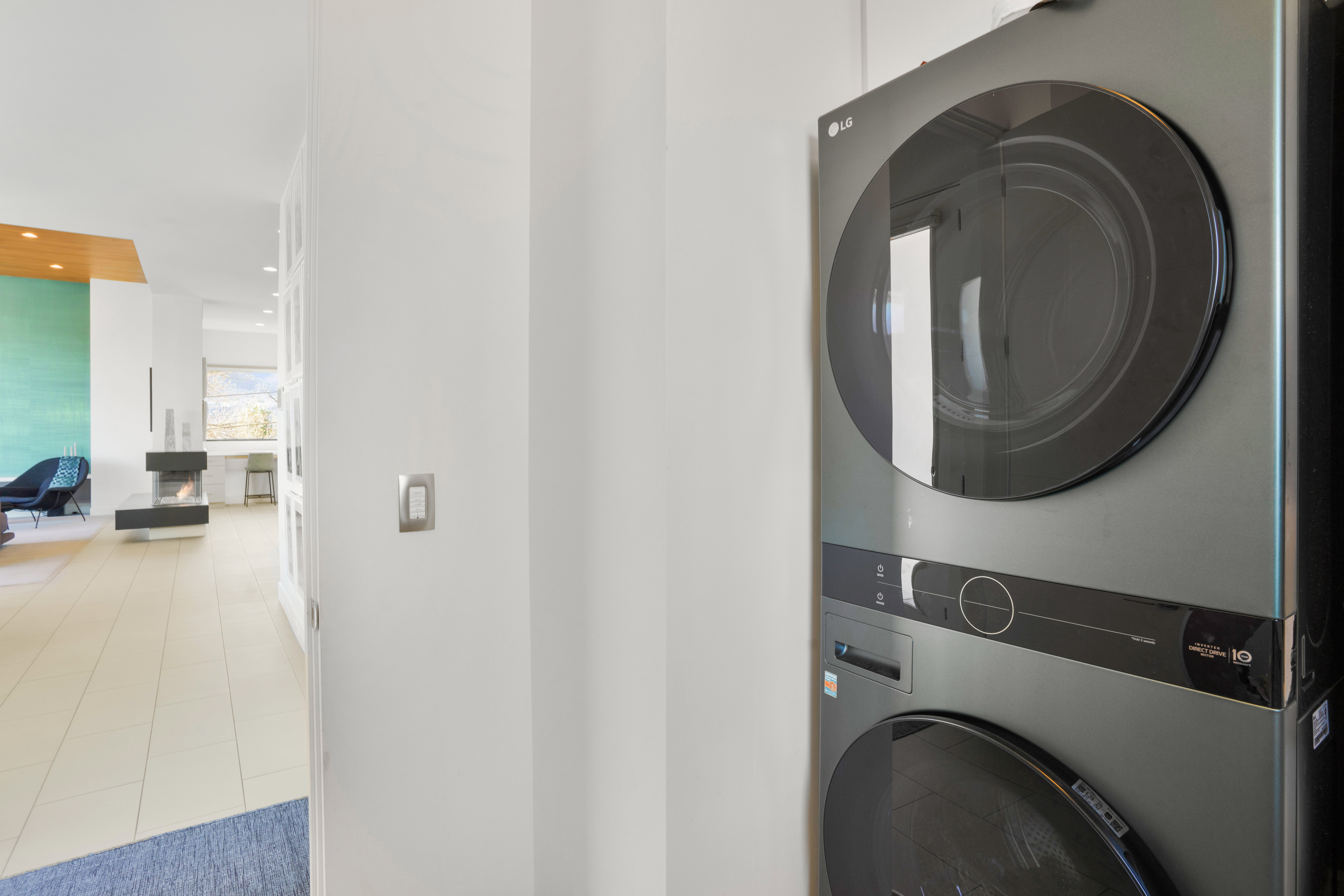 Laundry area featuring recessed lighting and stacked washer and dryer