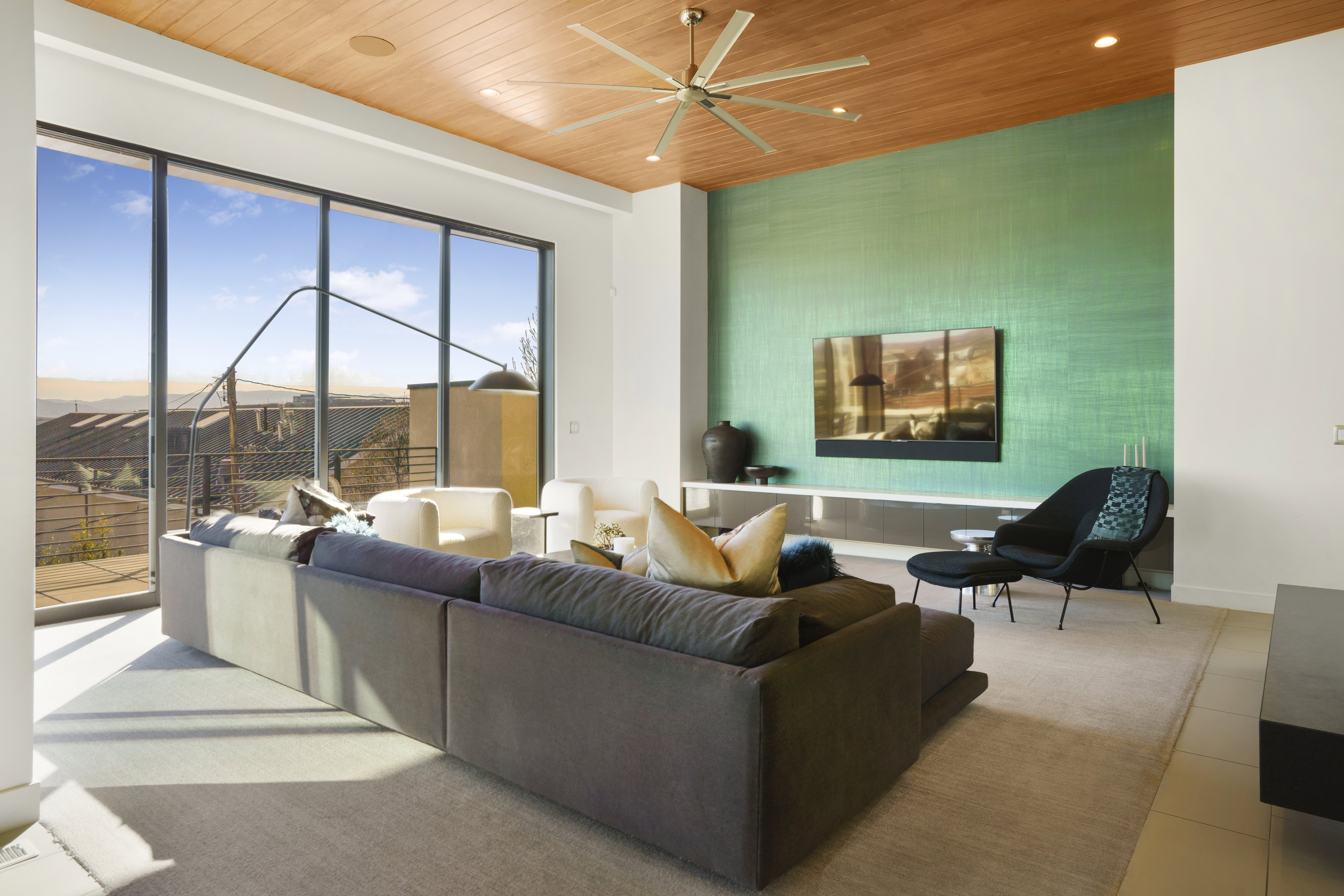 Living area featuring ceiling fan, wood ceiling, an accent wall, and recessed lighting