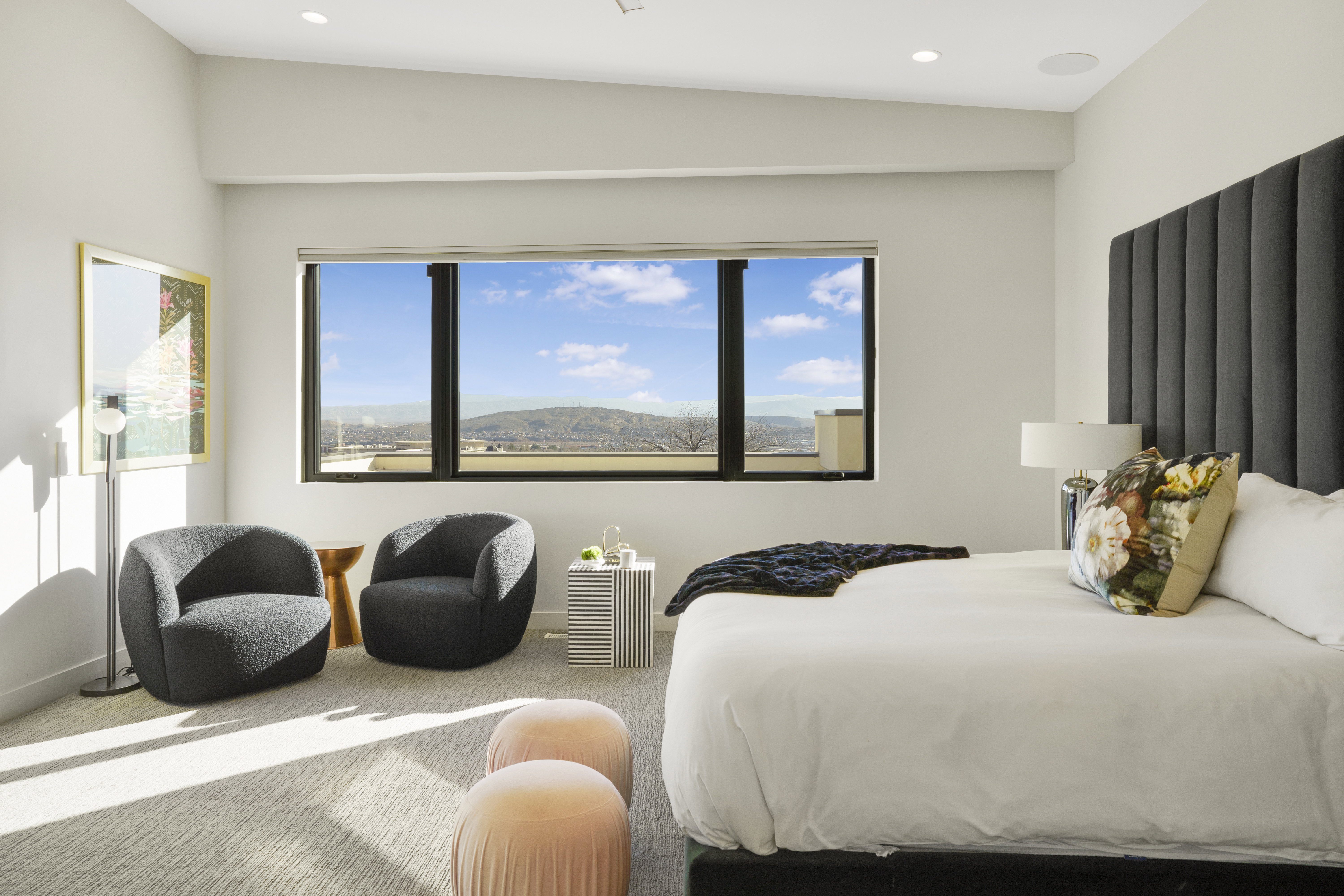 Carpeted bedroom featuring multiple windows, recessed lighting, and a mountain view