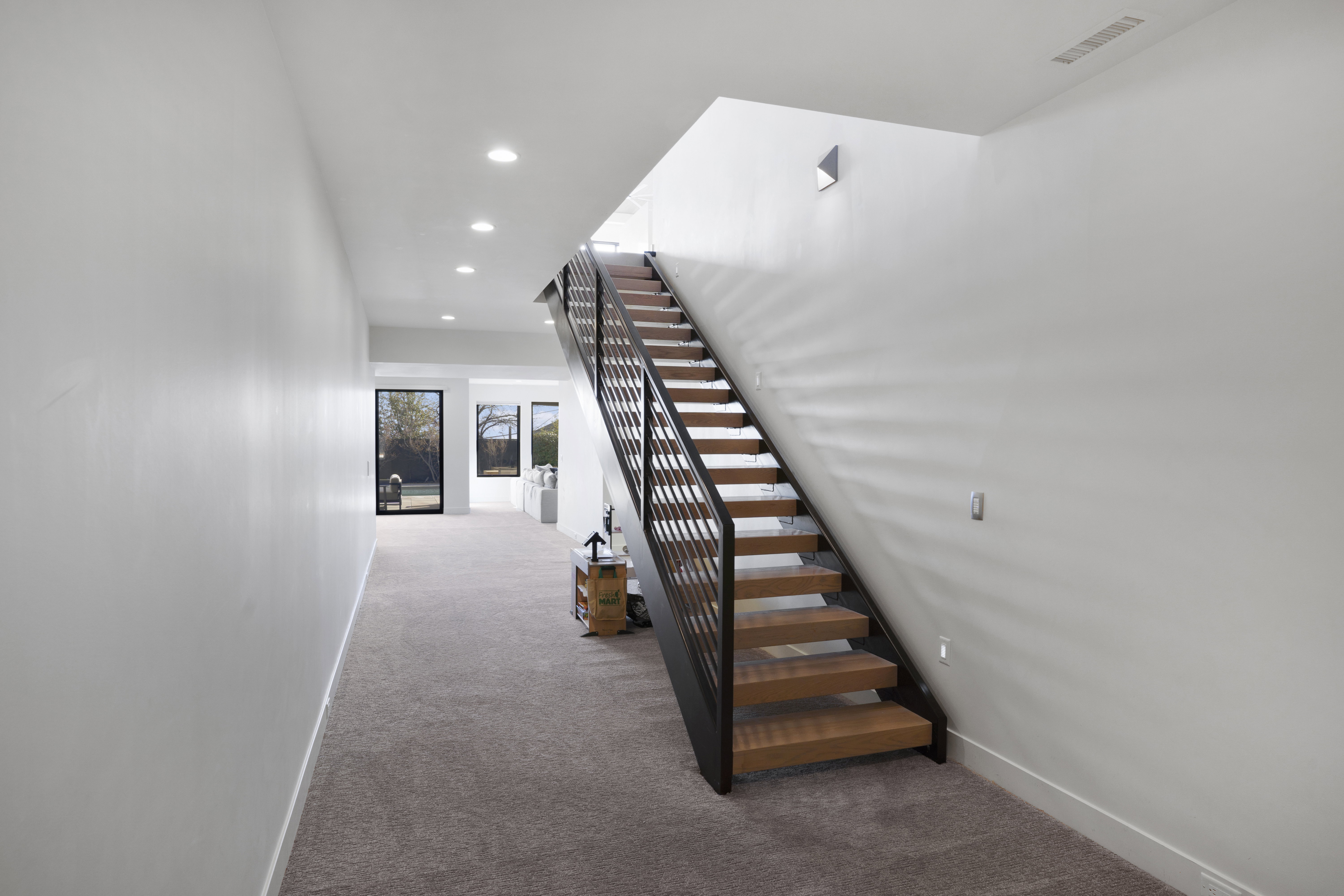 Staircase with recessed lighting and carpet floors