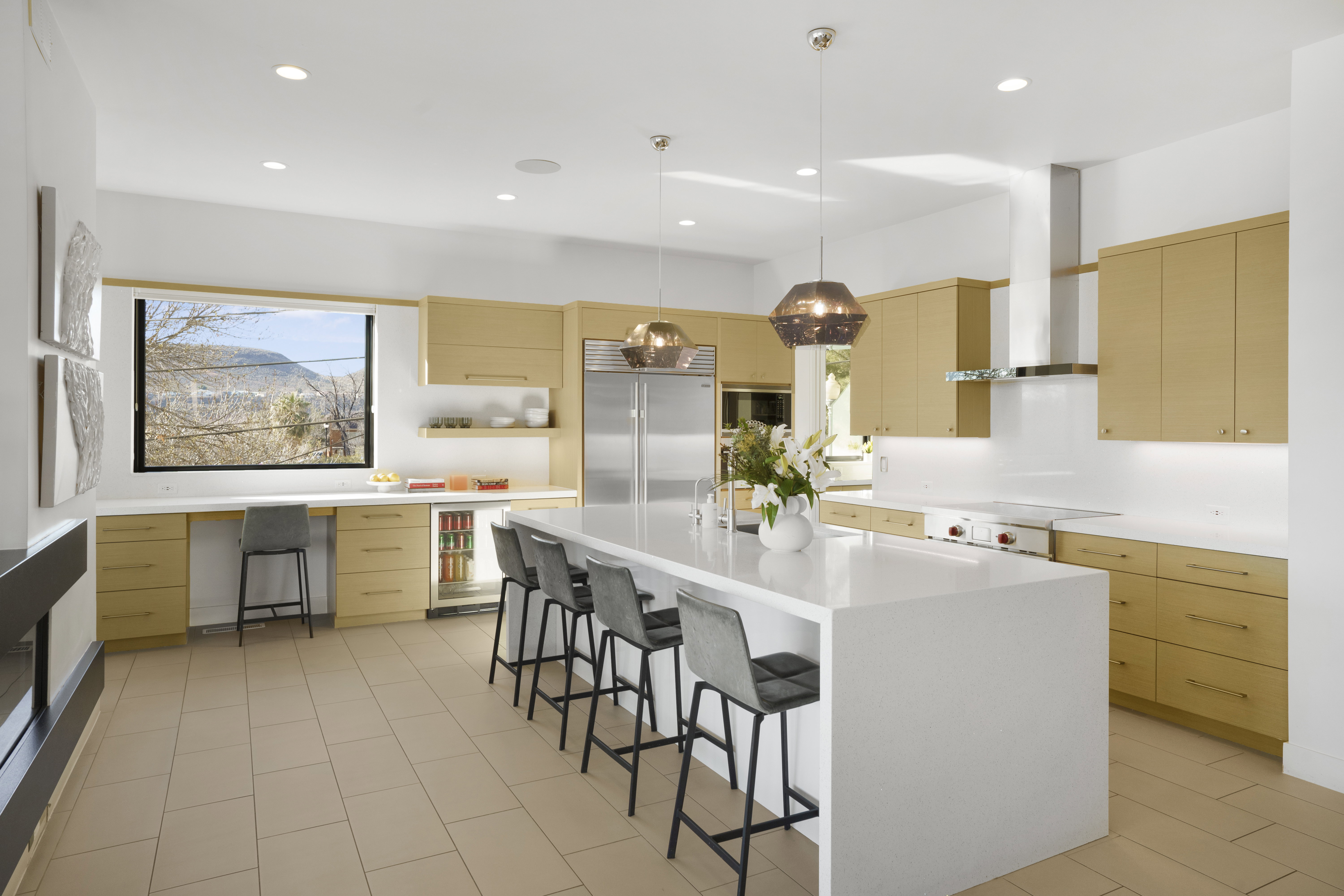 Kitchen featuring pendant lighting, a breakfast bar area, built in appliances, a center island, and open shelves