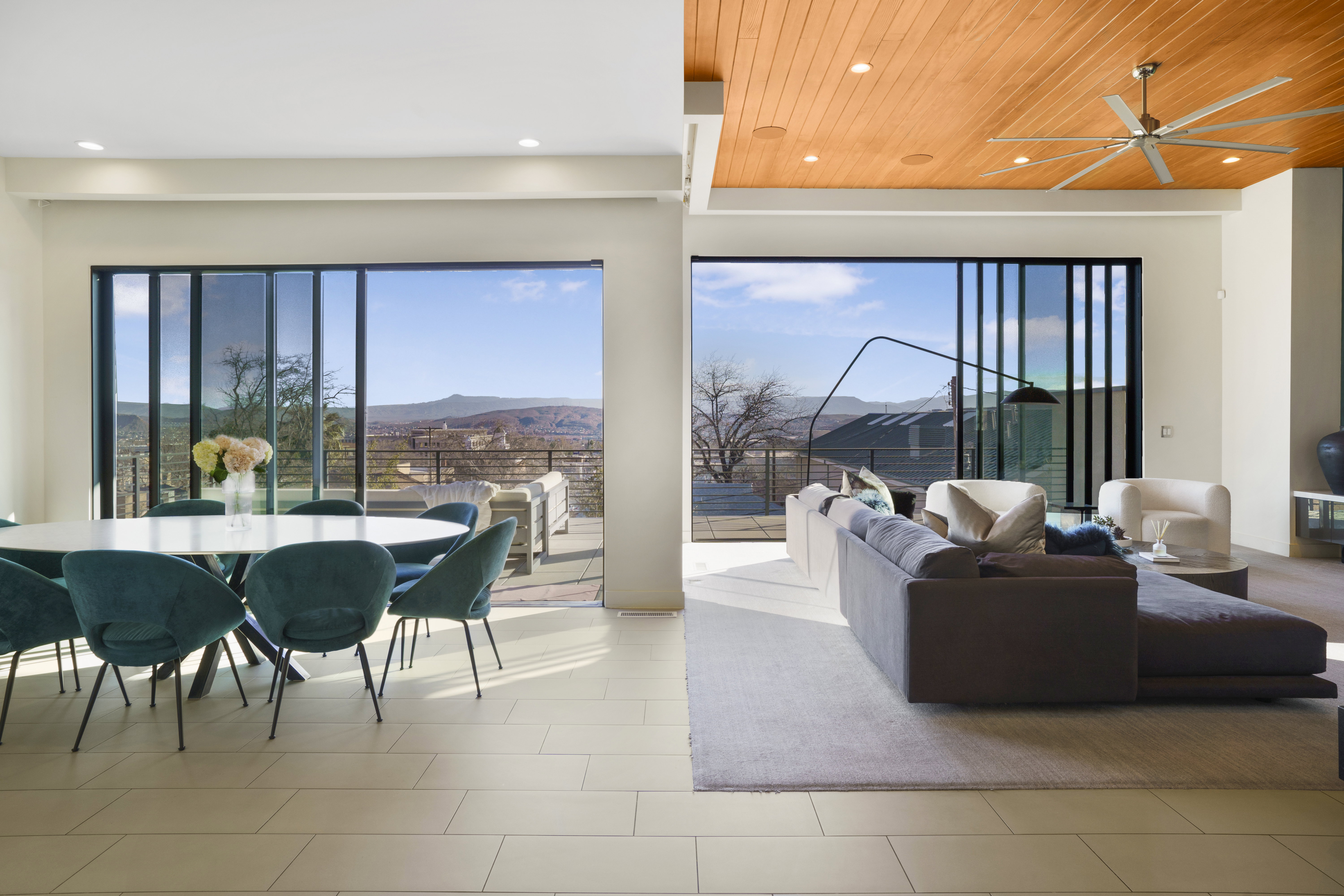 Living area with a mountain view, a ceiling fan, recessed lighting, and wood ceiling