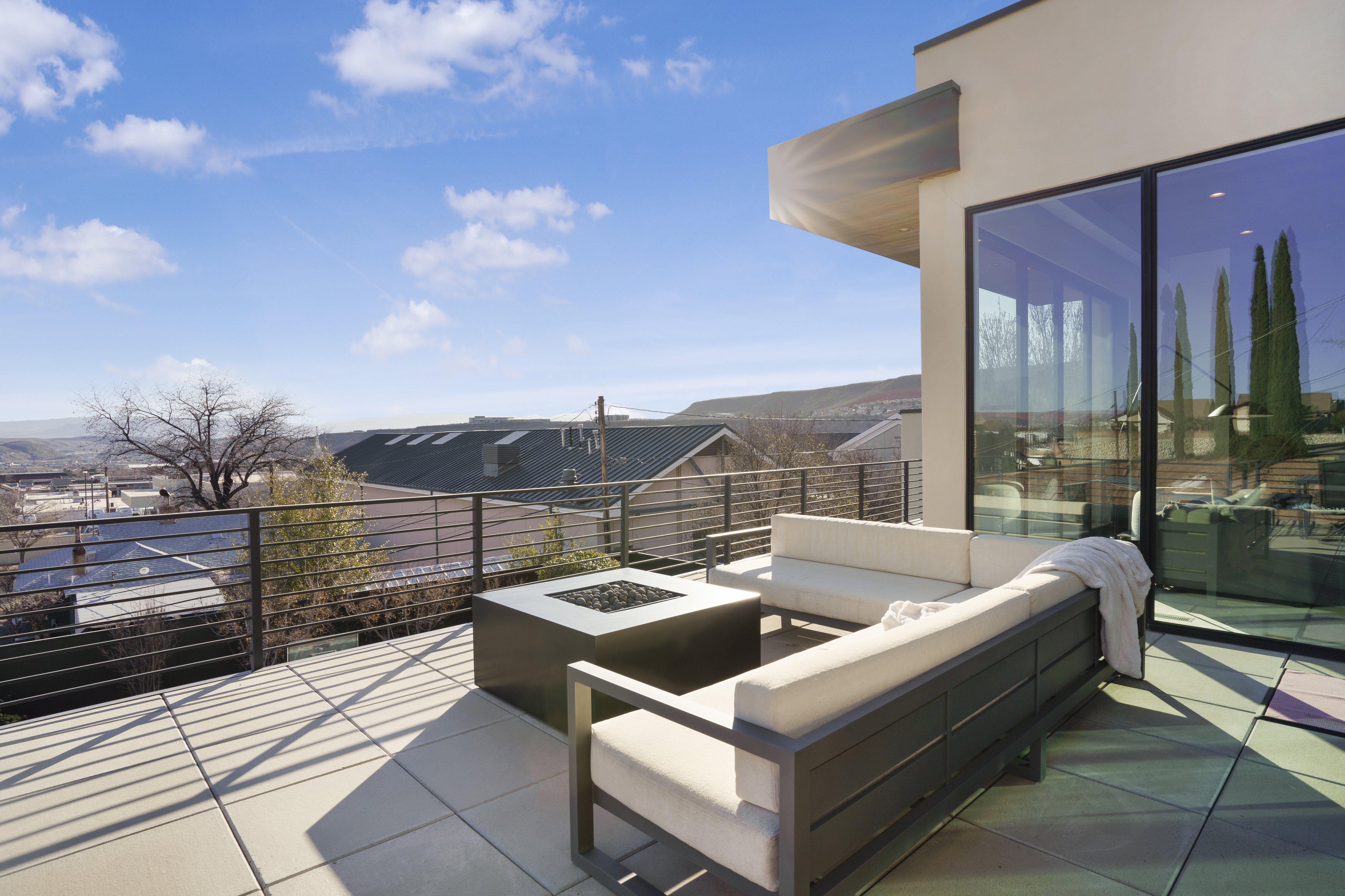 View of patio / terrace featuring an outdoor living space with a fire pit and a residential view