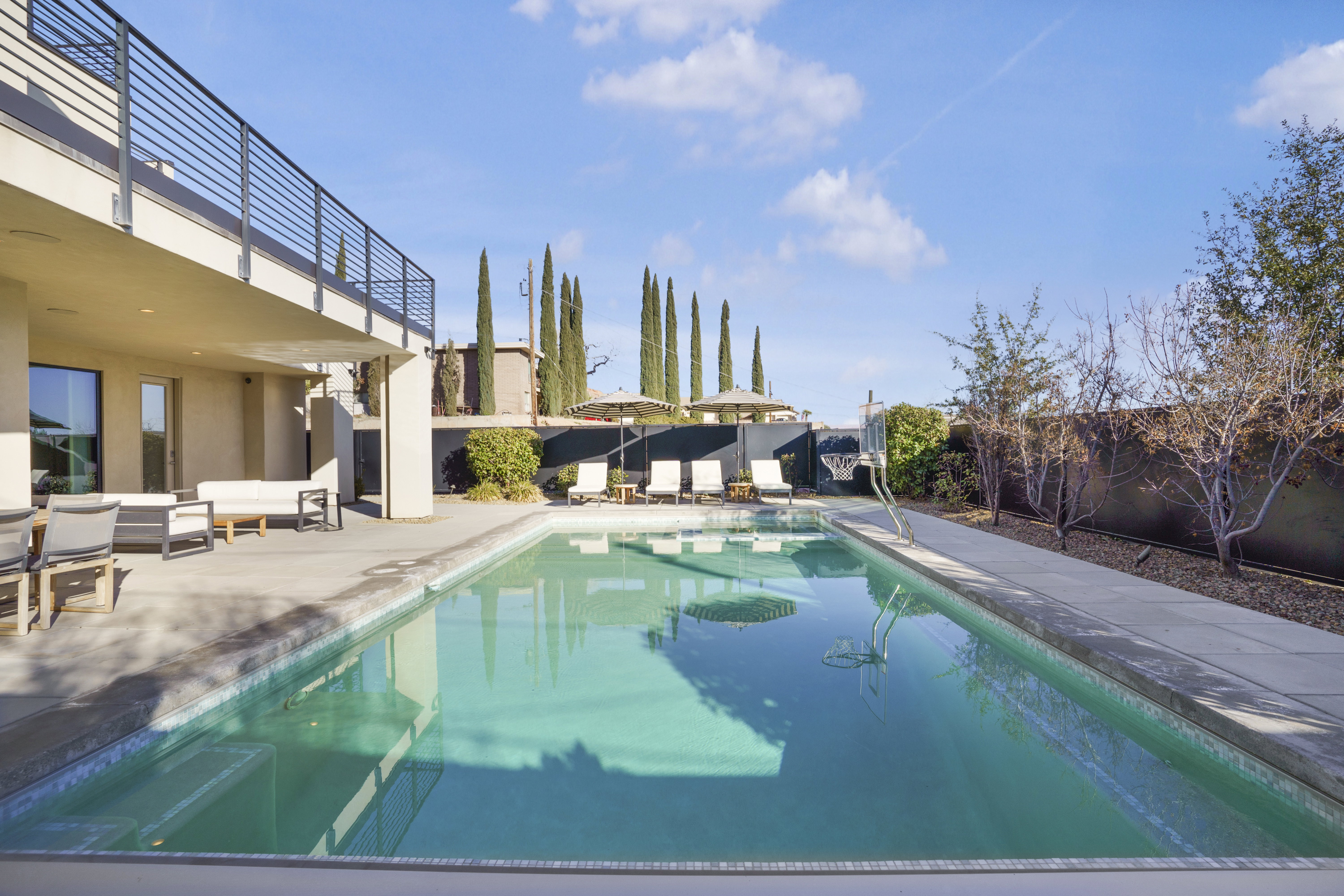 View of pool featuring patio surround and a fenced backyard