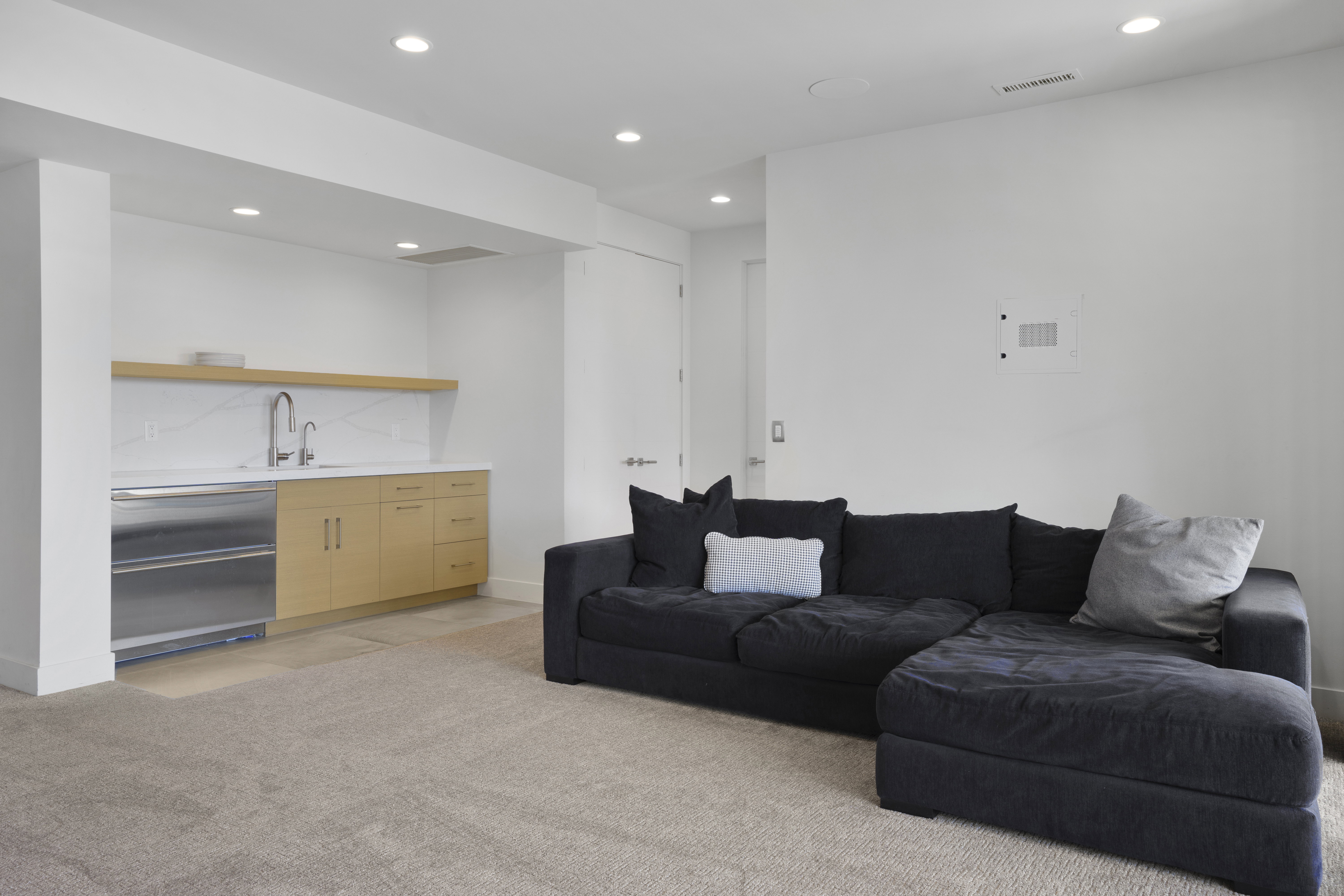 Living room with recessed lighting and light colored carpet