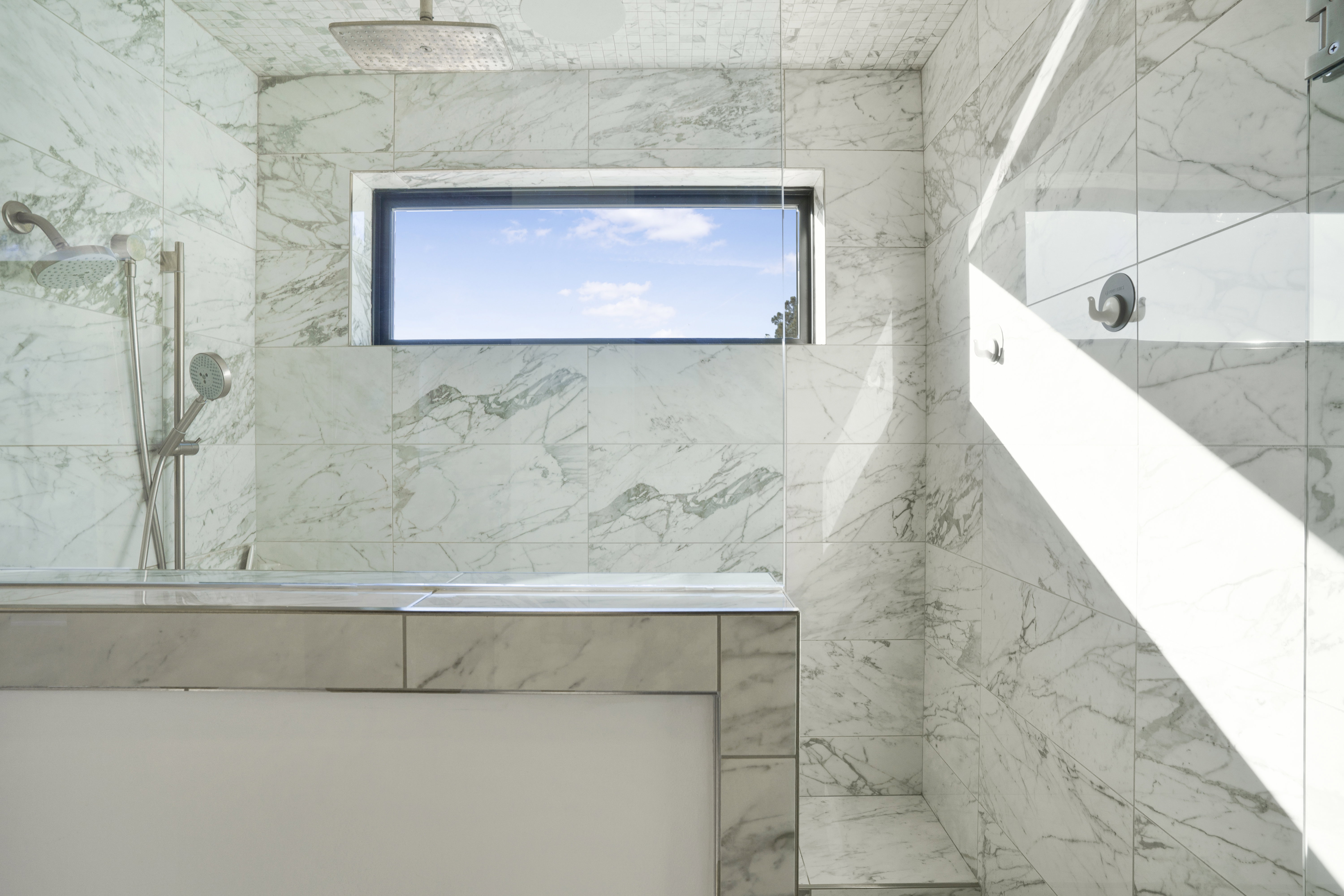 Bathroom featuring a marble finish shower