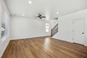 Unfurnished living room featuring hardwood / wood-style floors, ceiling fan, and recessed lighting