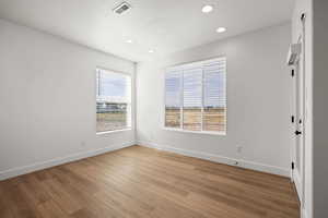 Spare room featuring light wood finished floors and recessed lighting
