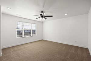 Empty room with light carpet and a ceiling fan