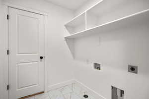 Laundry area featuring light marble finish flooring, washer hookup, and hookup for an electric dryer