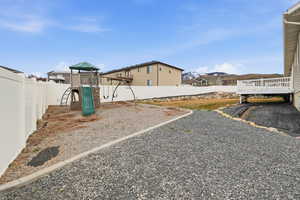 Fenced backyard with a playground
