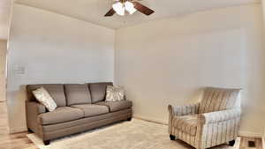 Living room with wood finished floors and a ceiling fan