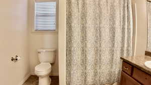 Bathroom with vanity, curtained shower, and tile patterned floors