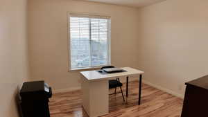 Office featuring light wood-type flooring and baseboards