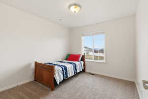 Bedroom with carpet flooring and baseboards