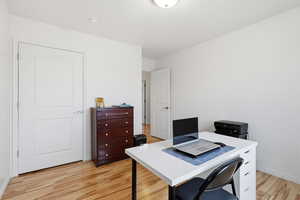 Office area with light wood-type flooring and baseboards