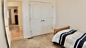 Bedroom featuring carpet floors and a closet