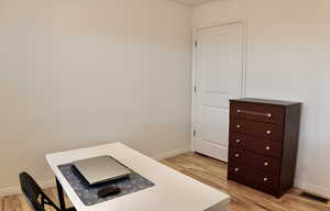 Office featuring light wood-type flooring and baseboards