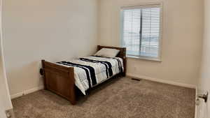 Carpeted bedroom with baseboards