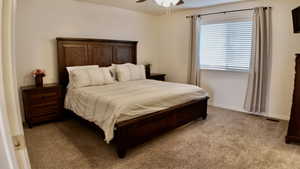 Bedroom with light carpet and ceiling fan