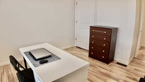 Office with light wood-style floors