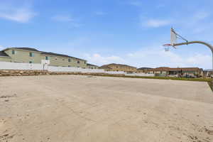View of sport court featuring community basketball court and a residential view